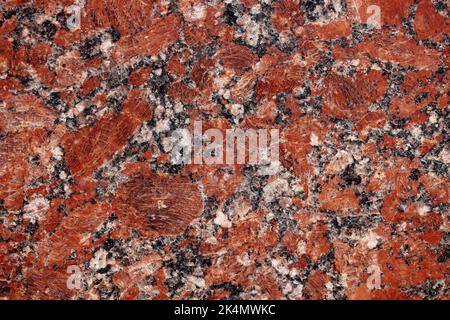 Nature granite texture background. Red granite tile texture close up. Polished decorative stone for photo design. Macro red grey granite decorative ti Stock Photo
