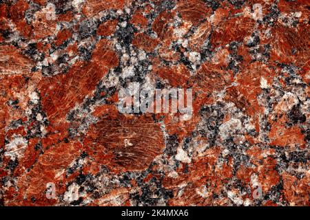 Nature granite texture background. Red granite tile texture close up. Polished decorative stone for photo design. Macro red grey granite decorative ti Stock Photo