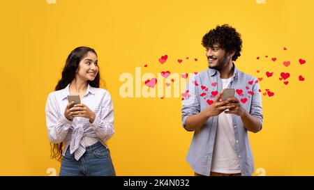 Cheerful young indian man and woman holding smartphones, collage Stock Photo