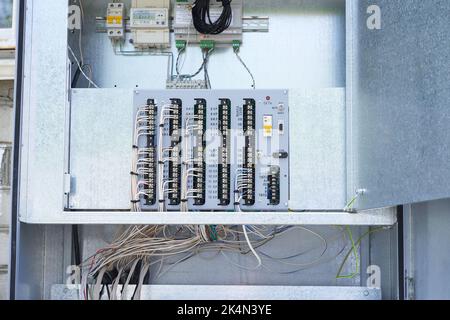 The wires are connected to the residual current circuit breakers and voltage monitoring relays. Electric control panel. High quality photo Stock Photo