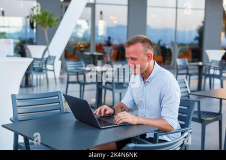 Successful male freelance businessman using laptop computer at work on vacation. Business, study, freelance. Remote work Stock Photo