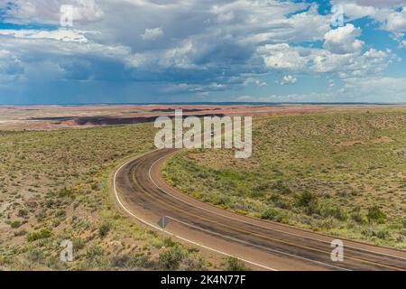Car driving on the remote roadway deep in the heart of the Petrified Forest National Park. Stock Photo