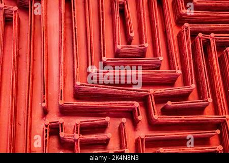 Decorative maze labyrinth made with nails and twine on wooden background Stock Photo
