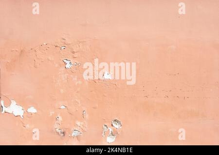 Pink pastel stonewall background texture. Aged peeled empty painted stucco wall structure, blank vintage surface for backdrop. Copy space. Stock Photo