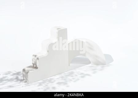 White concrete advertising stands with flower shadow. Gypsum podium for the presentation of cosmetic products on white background Stock Photo
