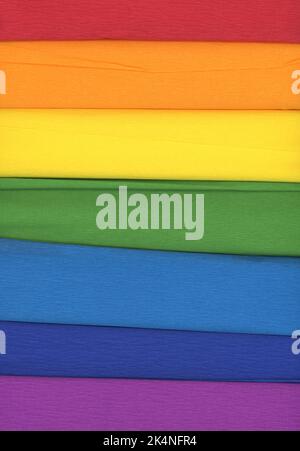 Colorful crepe rolls abstract background. 7 rolls of crepe paper horizontal. In the colors of the rainbow. Stock Photo