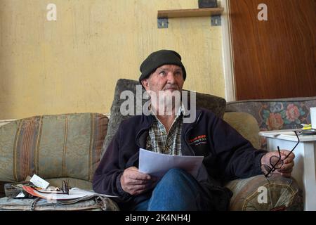 London, UK. Sept 29 2022 .Man with trying to cope with the raising cost of energy bills in his living room. Stock Photo