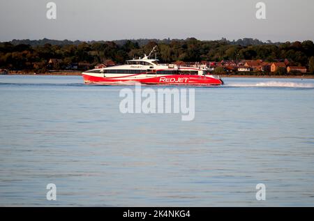Red Jet 6 Catamaran makes her way along Southampton Water. The high speed service operated by Red Funnel makes the crossing to Cowes in 28 minutes. Stock Photo
