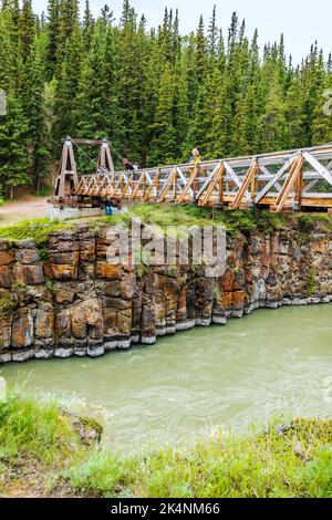 Visitors on bridge tour basalt rock formations; Miles Canyon; Whitehorse; Yukon Territories; Canada Stock Photo