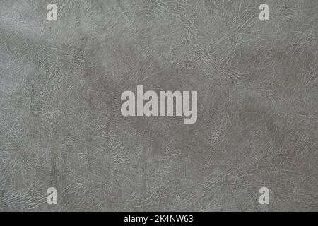 The texture of artificial leather. Background of black leather with patterns. Artificial material made of gray leather. Stock Photo