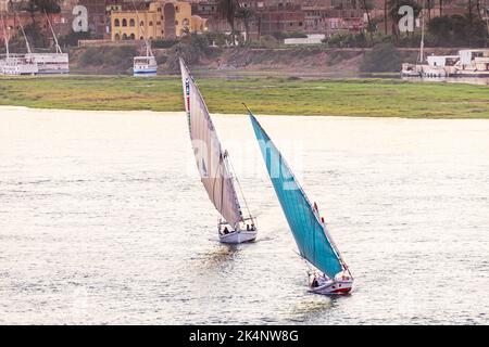 Edfu, Aswan, Egypt. February 25, 2022. Feluccas sailing on the Nile River in Edfu. Stock Photo