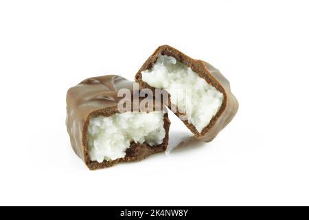 Two pieces of broken coconut filled chocolate bar isolated on white background Stock Photo