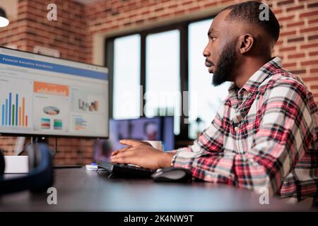 Business manager checking diagrams on computer, analyzing research data information on chars to create startup report and send email. Working remotely from home, doing freelance presentation. Stock Photo