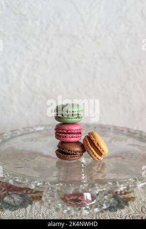 Stacked macarons on a glass plate Stock Photo