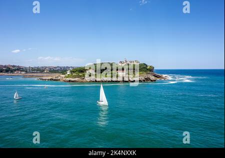 Mouro Island,or Mogro Island, is a small uninhabited island in the Bay of Biscay, located off the Magdalena Peninsula. just off Santander Spain Stock Photo