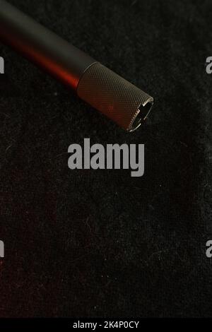 Muzzle of shotguns. Shotgun - macro shooting. Muzzle end of the barrel on a black cloth background. Hunting rifle. Stock Photo