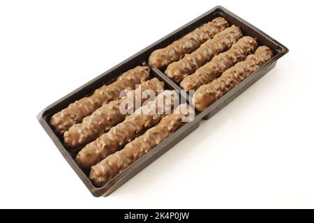 Chocolate coated wafer sticks in plastic package isolated on white background Stock Photo