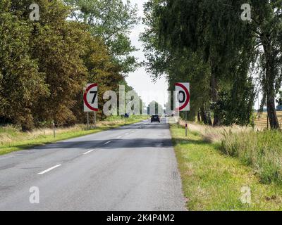 Poland - august 12, 2018: countryside sliding road with bizarre speed indicator sign Stock Photo