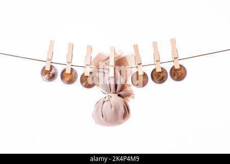 Coins on a rope on a white background, euro bills, hung by wooden clothespins hanging clothes. Drying money Cleaning or laundering. Money caught by Stock Photo