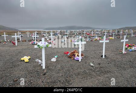 Cemetery with artificial flowers on the Arctic coast at Apex, Nunavut Stock Photo