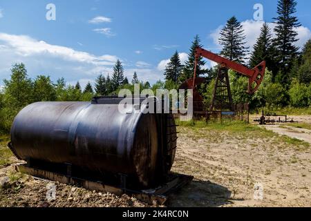 An oil rig pumps oil from underground to the surface Stock Photo