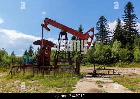 An oil rig pumps oil from underground to the surface Stock Photo