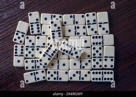 Dominoes scattered on the wooden table Stock Photo