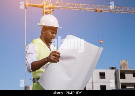 African American architect compares building to drawings Stock Photo