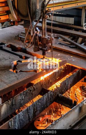 Industrial cnc machine for cutting metal plasma. Sparks and flame. Stock Photo