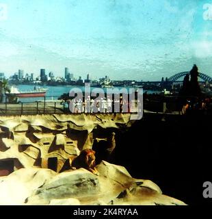 1971 - Taronga Park Zoo and the Sydney, Australia skyline as it was at that time showing the lion enclosure and Sydney Harbour Bridge to the right. Though almost complete, the Opera House was  not formally opened by Queen Elizabeth II until 20 October 1973 Stock Photo