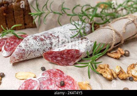 Still life of salami sausage with bread and nuts. Stock Photo
