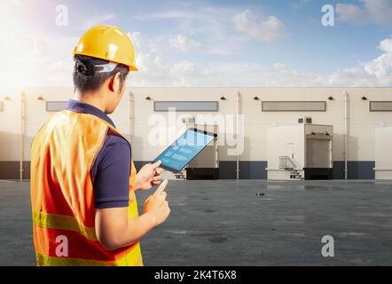 Asian worker or engineer work at warehouse with digital tablet Stock Photo
