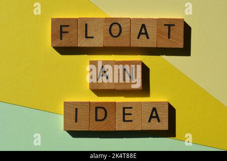 Float An Idea, words in wooden alphabet letters isolated on yellow and green background. Business jargon meaning to see if someone is in agreement or Stock Photo