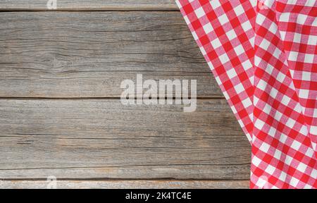 Checkered tablecloth on a wooden background. Stock Photo