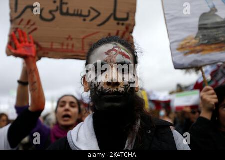 A protester wearing face-paint depicting France's iconic 