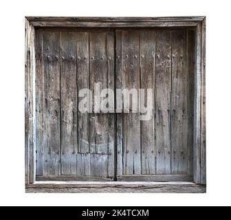 front view closeup of vintage wooden barn door with weathered wood dark texture and metallic lock and bolts isolated on white background Stock Photo