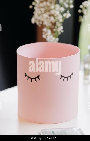 Pink round gift box on white table Stock Photo