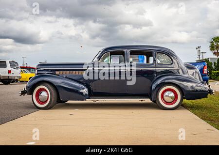 Daytona Beach, FL - November 28, 2020: Low perspective side view of a 1937 Buick Century Series 60 Model 64 Touring Sedan at a local car show. Stock Photo