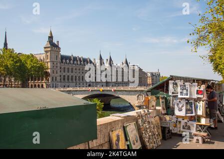 Paris, France. August 2022. Bookstall along the Seine with the Conciergerie in the background. High quality photo Stock Photo