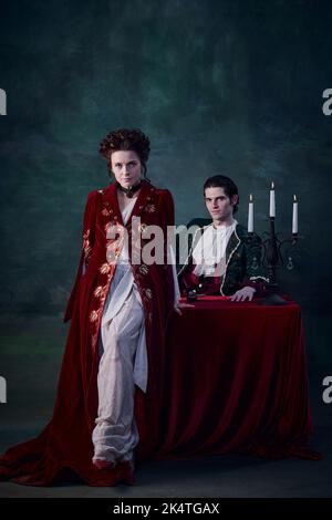 Portrait of vampire dracula young woman dress in white tone room ...