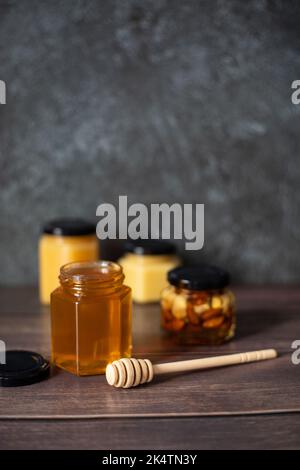 Nuts with honey in glass jars. Harvest of nuts. Delicacy and Healthy food.  Homemade preservation in autumn Stock Photo - Alamy