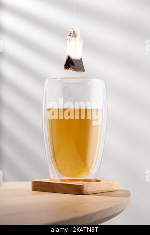 Tea glass cup with tea bag on the wooden  table Stock Photo