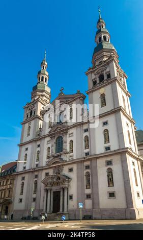 The front facade of the church Stift Haug in Würzburg, Germany. Above the portal is a figure of the church patron John the Baptist, in the other niche... Stock Photo