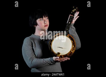 Previously unissued photo dated 08/09/22 of a Propstore employee holds George Harrison's Calls 'E' Banjolele (estimate £40,000-60,000) during a preview for the upcoming Propstore Entertainment Memorabilia Live Auction in London, which will be held over 4 days from 3rd to 6th November. LIVE Picture date: Thursday September 8, 2022. Stock Photo