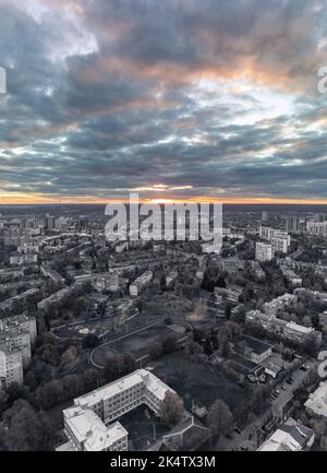 Aerial evening autumn view on grayscale Kharkiv city Pavlove Pole district. Multistory buildings residential area with vibrant colorful sunset sky Stock Photo