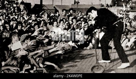 Photo taken from TV Radio Mirror, March 1957 - Elvis performing live at the Mississippi-Alabama Fairgrounds in Tupelo, Mississippi. Stock Photo