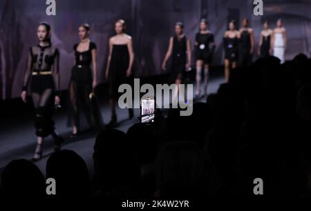 Paris, France. 4th Oct, 2022. Models present creations from the Spring/Summer 2023 Ready-to-Wear collection of Chanel during the Paris Fashion Week, in Paris, France, Oct. 4, 2022. Credit: Gao Jing/Xinhua/Alamy Live News Stock Photo