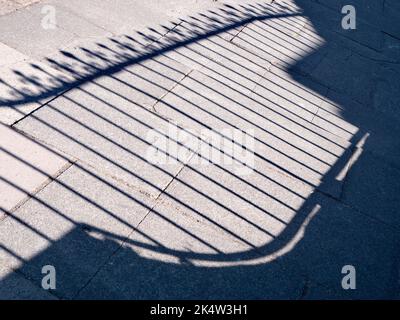 In the right time and place, even the everyday and ordinary can become fascinating. Take this abstract pattern on the pavement, the shadow of a decora Stock Photo