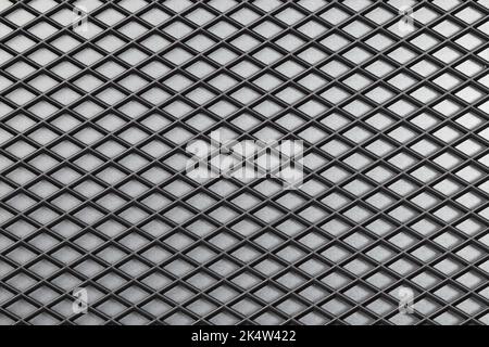 The background and texture of the fabric. Speaker cover, corduroy, polypropylene background. Close-up of black speaker surface texture. Woven mesh sur Stock Photo