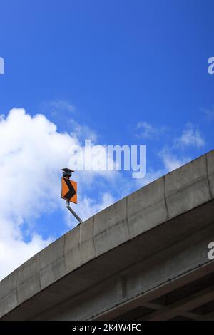 Winding road sign, Traffic sign on the road, Right chevron traffic sign on the bridge or curve road background with blue sky. Stock Photo